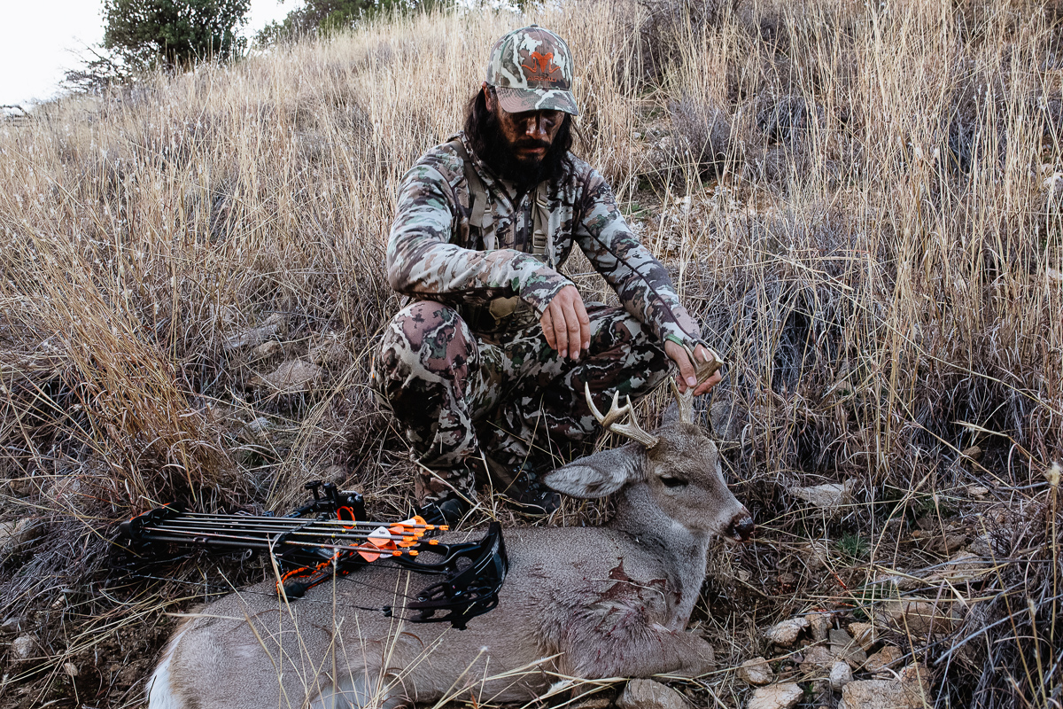 Josh Kirchner from Dialed in Hunter admiring his 2020 archery coues buck taken in Arizona