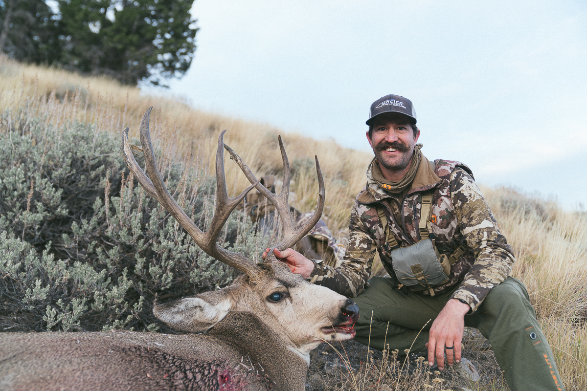 Kurtis Brooks with his rifle mule deer buck